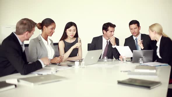 Office workers chatting during business meeting