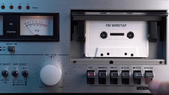 FBI Wiretap Audio Cassette Tape Recording Hand Placing Tape and Pressing Play