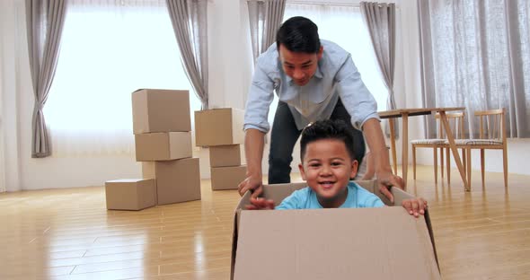 Family Is Having Fun With Cardboard Boxes In New House