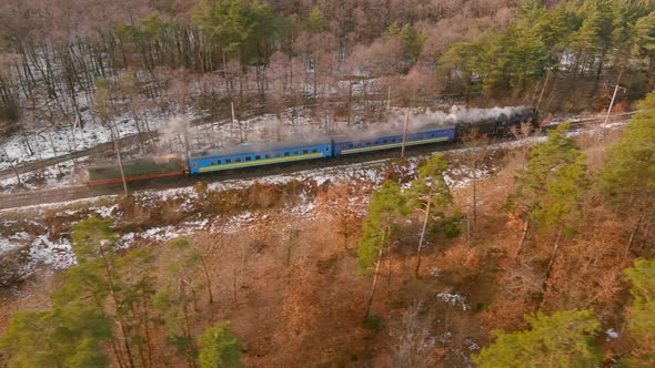 Aerial of an Antique Restored Steam Locomotive Blowing Smoke Steam Traveling