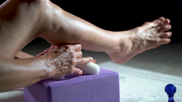 Low extreme closeup view of mature woman using a massage tool for myofascial therapy on her leg’s ca