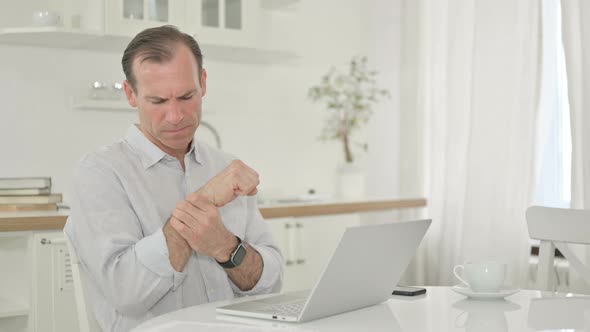 Exhausted Middle Aged Man Having Wrist Pain 