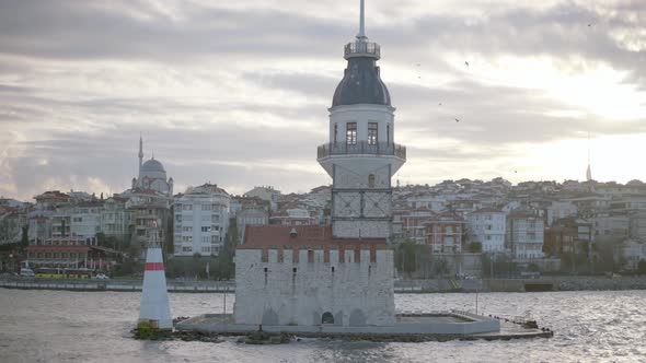 Old tower on small island in background of city