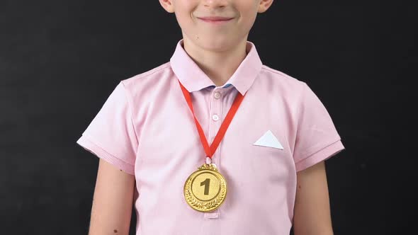 Smiling Schoolboy With First Place Medal Looking at Camera, Diligent Student