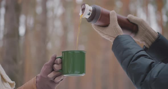 Two lesbians are drinking tea outdoor Girl is pouring tea LGBTQ Lesbian Bisexual Love