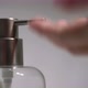 A Woman Uses a Dispenser with Antibacterial Soap or Antiseptic - VideoHive Item for Sale