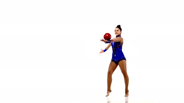 Active Young Girl Gymnast with Acrobatics Ball