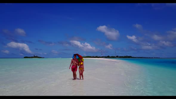 Man and lady sunbathe on paradise bay beach adventure by blue lagoon with white sandy background of 