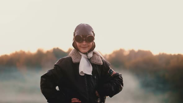 Beautiful Portrait of Little Girl in Old Pilot Flight Jacket and Glasses on Sunset