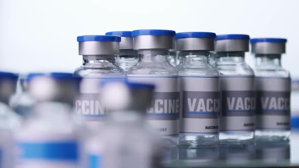 Glass vials for vaccine in laboratory. Group of vaccine bottles. Medicine in ampoules.