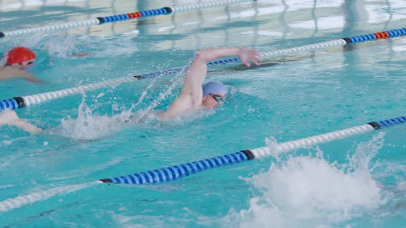 Swimmers swimming into the pool