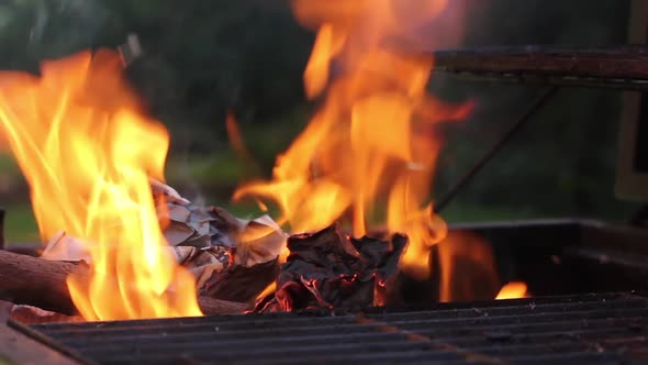 Sheets of Paper burning on a Portable BBQ.