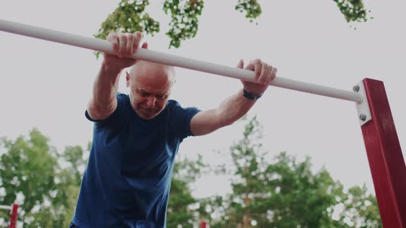 Grandfather or Grandpa Training on Outdoor Sports Playground