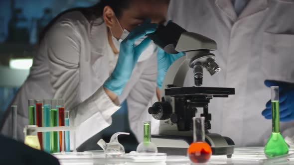 Woman Looking Trough Microscope alt