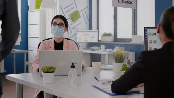 Business People with Medical Face Masks Working Together in New Normal Office