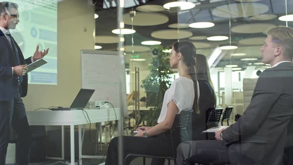 Male Executive Delivering Presentation before Colleagues