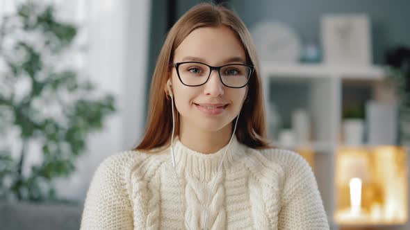 Portrait of Young Woma in Eyeglasses Sitting at Home