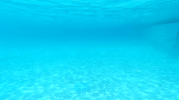 Pure Blue Water in the Pool with Light Reflections