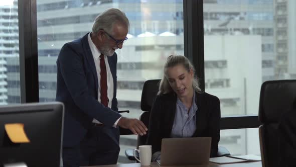 Senior Manager Gives Advice to Young Woman Worker