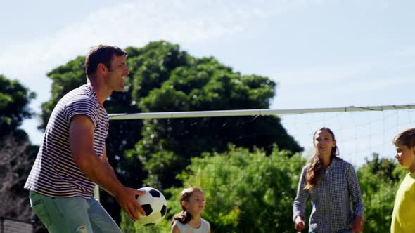 Happy family playing football