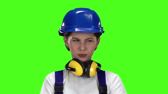 Builder Girl Shows Thumbsdown . Green Screen. Slow Motion