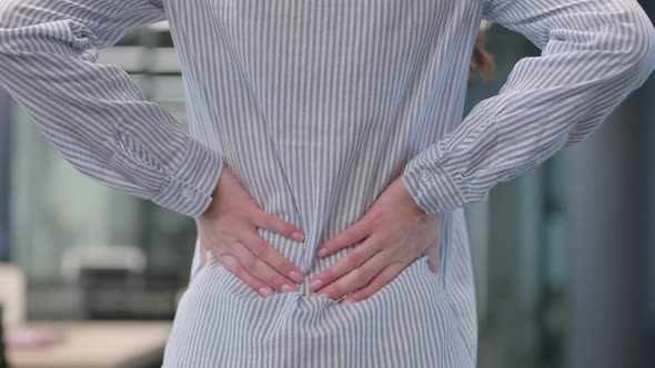 Close up of Woman Holding Back while having Pain