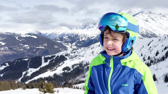 Laughing Young Boy in Ski or Snowboard Outfit Smiling Portrait