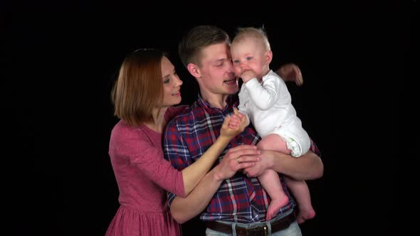 Video of Happy Family of Three People. Father, Mother, Baby Playing. Black