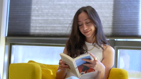 Girl Reading Book in Home