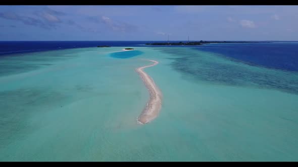 Aerial seascape of marine seashore beach voyage by aqua blue water with white sandy background of a 