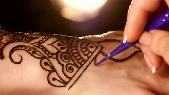 Process of Applying Mehndi on Hand Close Up, Back Light, Black