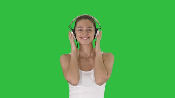 Woman with headphones listening music and making funny