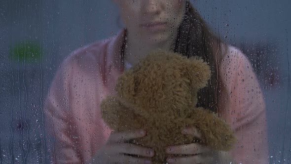 Sad Female With Wound on Cheek Hugging Teddy Bear, Remembering Happy Childhood