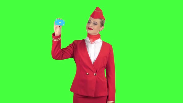 Girl Raises a Card and Shows a Points a Hand at Her. Green Screen