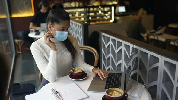 A Girl Sitting in a Coffee Shop with Headphones