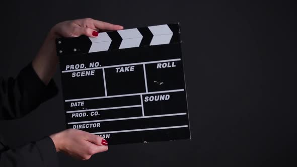 Clapper Board in Action on a Gray Background