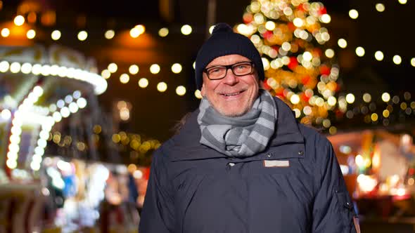 Happy Senior Man Smiling at Christmas Market 18