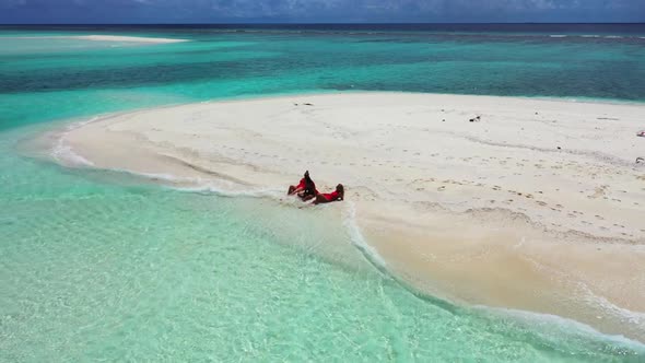 Beautiful ladies tanning on perfect island beach trip by shallow water and clean sand background of 