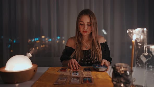 Woman Reading Tarot Cards in Spiritual Room