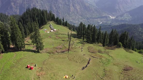 Hikers Trekking In Sar Pass Trek In A Sunny Afternoon  Aerial Shot