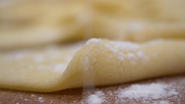 Sprinkling compound powder on readymade faworki angel wings macro