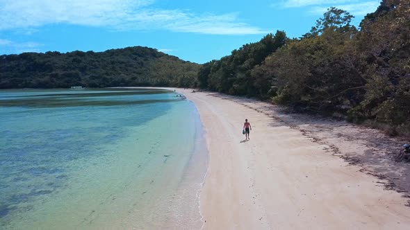 Man Walking Along The Seashore Of Palawan Island In The Philippines