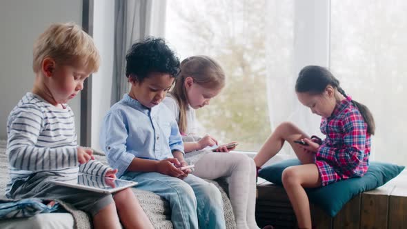 Little Children Playing on Gadgets at Home