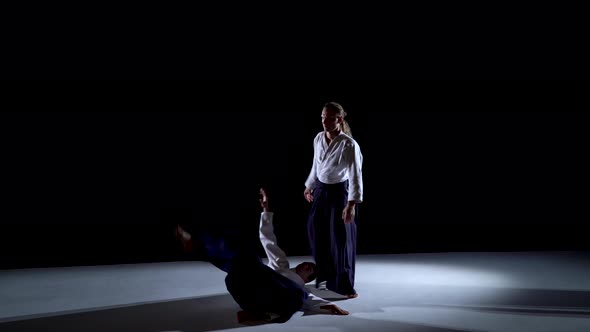 Two Aikido Masters Participants of the Training in Special Clothes of Aikido Hakama Work Out the