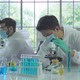 Asian Scientist working on blue test tube to analysis and develop vaccine of covid-19 - VideoHive Item for Sale