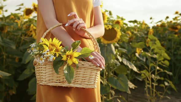 A Woman is Holding a Basket of Flowers