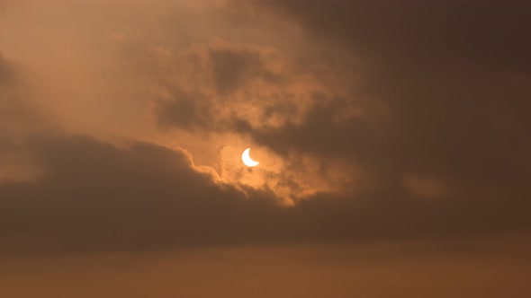 Partially solar eclipse through the thick cloud 
