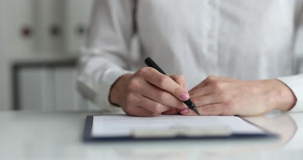 Woman Examining Document on Clipboard and Signing It with Fountain Pen Closeup  Movie Slow Motion