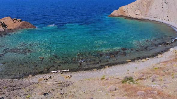 Clear and Shallow Sea Water of the Cove Surrounded by Stone and Rocky Coastline