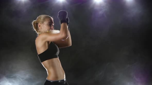 Woman Boxer Makes the Punching and Kicking. Close Slow Motion